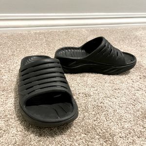 Hoka one one black slides, size 5. Excellent condition.  Barely worn.